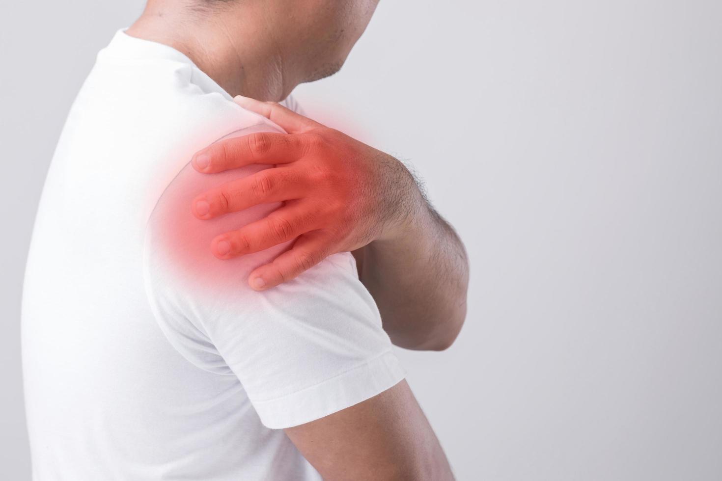 close-up-man-touching-his-shoulder-and-feeling-a-pain-studio-shot-isolated-on-grey-background-with-copy-space-for-text-free-photo