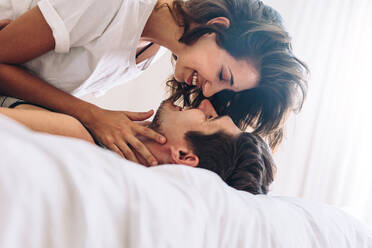 loving-young-couple-together-in-bed-romantic-couple-about-to-kiss-JLPSF13350 (1)