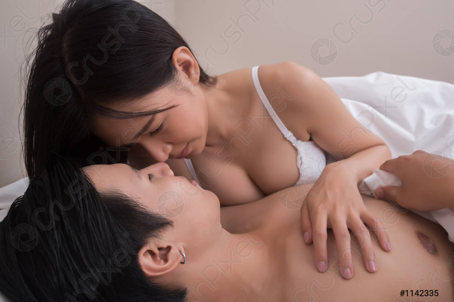 young-couple-foreplay-bed-1142335