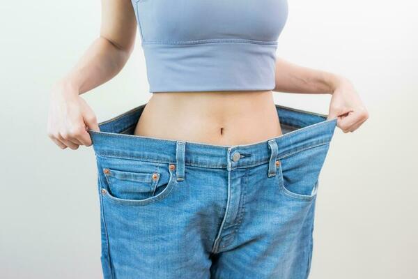 shape-slender-thin-waist-attractive-slim-asian-young-woman-hand-show-shape-her-weight-loss-wearing-in-big-large-or-oversize-jeans-excess-lose-by-diet-and-exercise-people-body-fit-healthy-photo